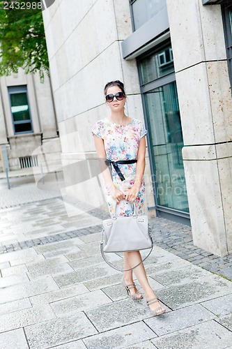 Image of attractive woman with sunglasses in the city summertime