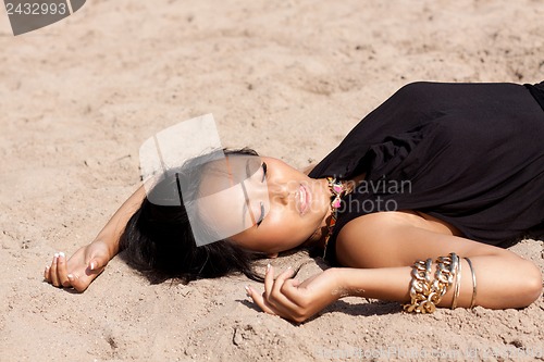 Image of beautiful asian woman with colorful makeup on the beach 