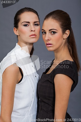 Image of two beutiful brunette girls in casual fashion and accessory 