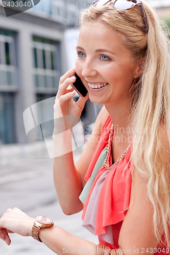 Image of attractive young blonde woman city lifestyle outdoor