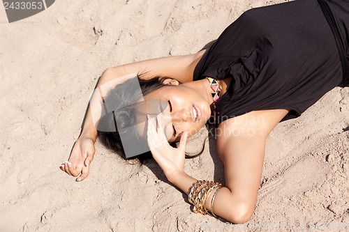 Image of beautiful asian woman with colorful makeup on the beach 