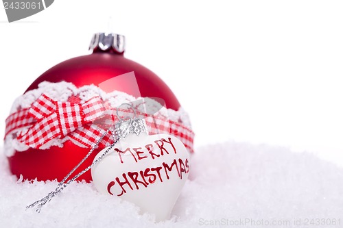 Image of christmas decoration festive red bauble in snow isolated