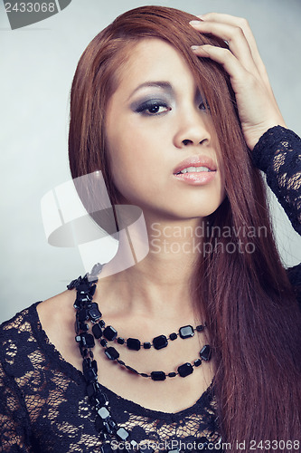 Image of pretty asian girl with long hair and luxury ring