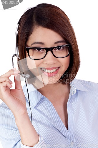 Image of young smiling asian businesswoman call center agent isolated