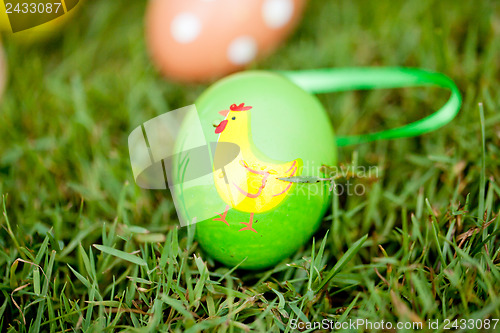 Image of colored easter eggs group in green grass outdoor in spring