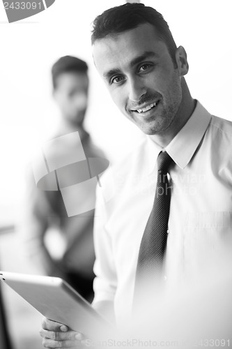 Image of business man using tablet compuer at office