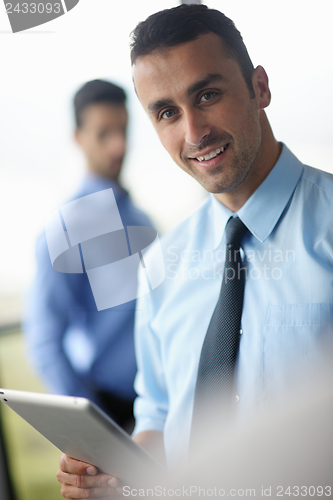 Image of business man using tablet compuer at office