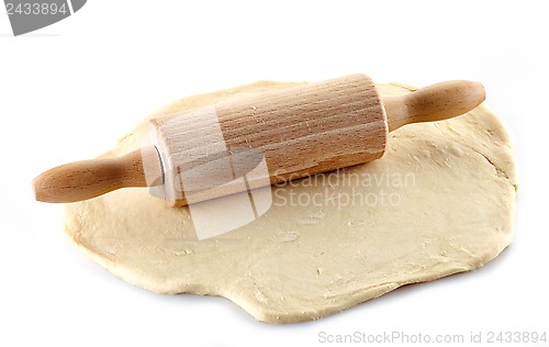 Image of Wooden rolling pin and dough