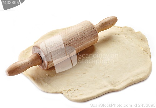 Image of Wooden rolling pin and dough