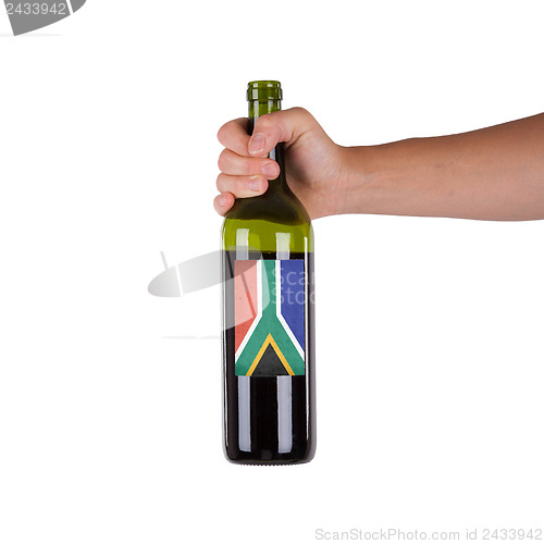 Image of Hand holding a bottle of red wine