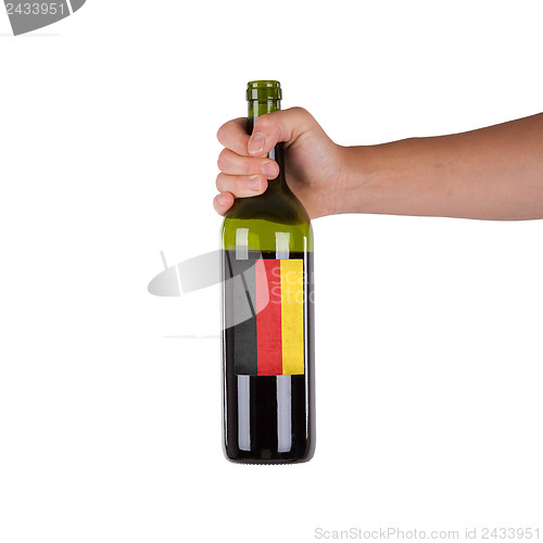 Image of Hand holding a bottle of red wine