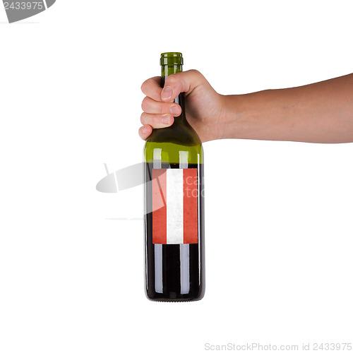 Image of Hand holding a bottle of red wine