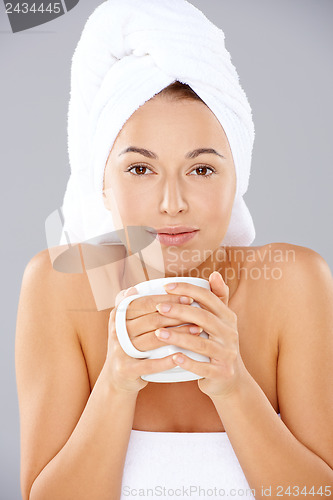 Image of Beautiful woman enjoying coffee at a spa