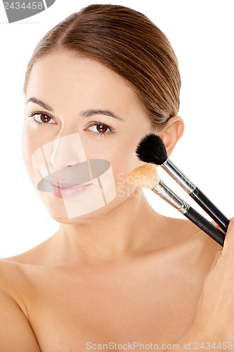 Image of Beautiful woman holding two cosmetic brushes