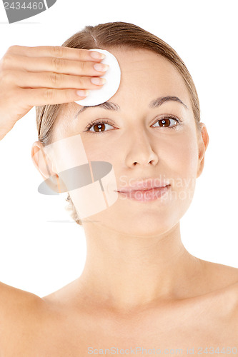 Image of Beautiful woman holding a cotton pad