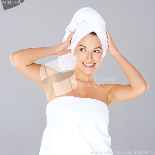 Image of Vivacious woman wrapped in white towels