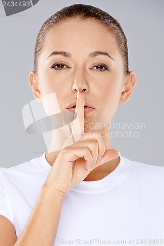 Image of Woman making a shushing gesture