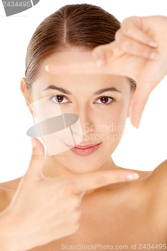 Image of Woman framing her face with her fingers