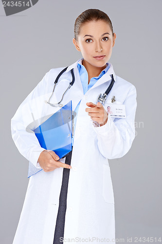 Image of Young woman doctor pointing at the camera