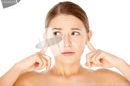 Image of Woman blocking her ears with her fingers