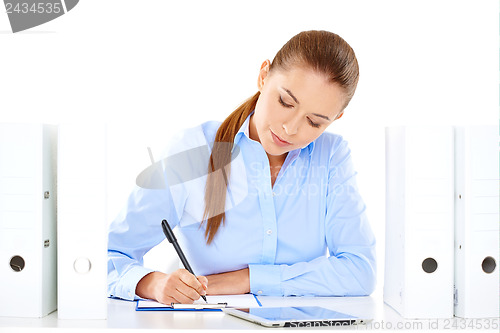 Image of Efficient businesswoman working at her desk