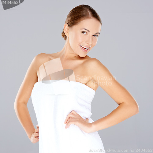 Image of Smiling woman posing in a white towel