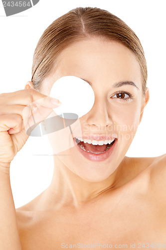 Image of Laughing woman holding a cotton pad to her eye