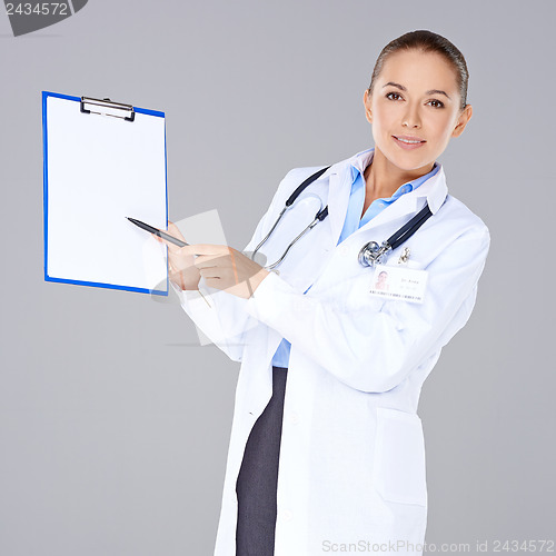 Image of Female doctor displaying a blank clipboard