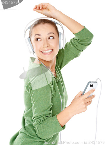 Image of Happy woman dancing to her music