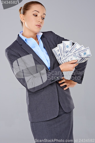 Image of Successful businesswoman with a wad of money