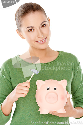 Image of Woman contemplating opening her piggy bank