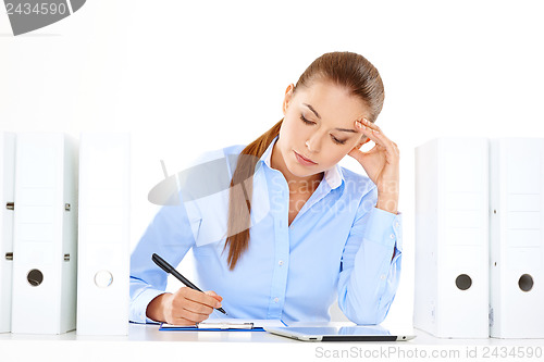 Image of Efficient businesswoman working at her desk