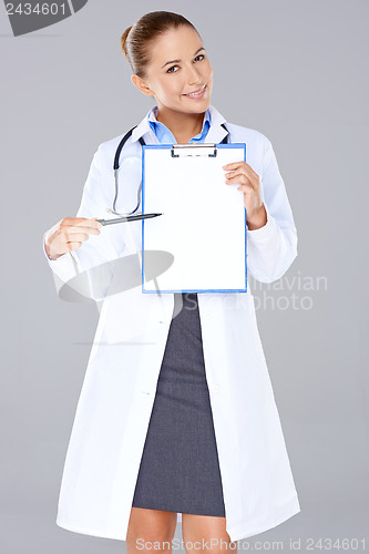 Image of Female doctor displaying a blank clipboard