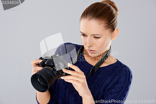 Image of Female photographer checking an image