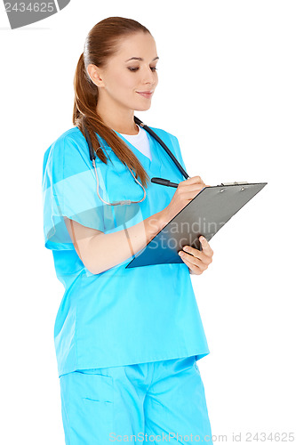 Image of Pretty young nurse writing up notes