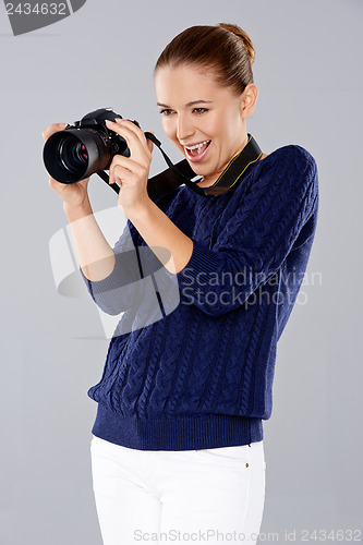 Image of Female photographer assessing her shot