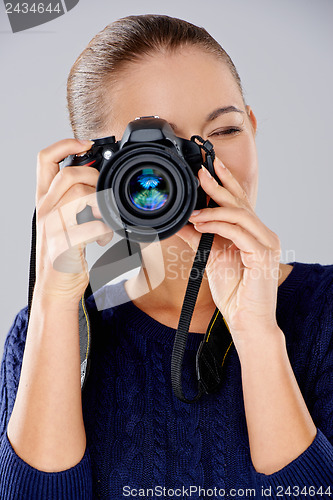 Image of Female photographer taking a photo