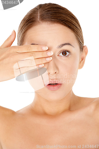 Image of Naked woman concealing one eye