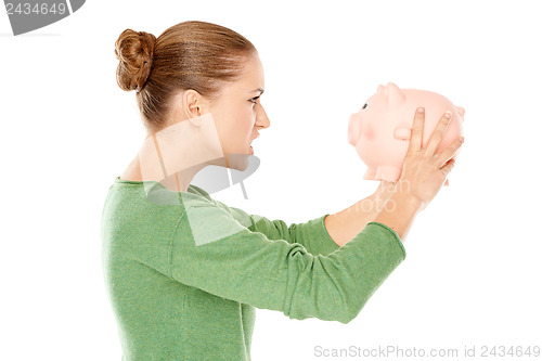 Image of Angry woman arguing with her piggy bank