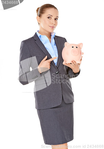 Image of Businesswoman holding a piggy bank