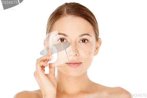 Image of Beautiful woman cleaning her face