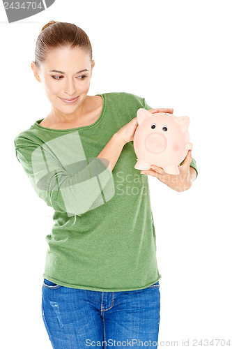 Image of Woman giving her piggy bank a speculative look