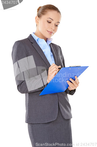 Image of Businesswoman writing notes on a clipboard