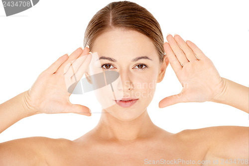 Image of Beautiful woman framing her face with her hands