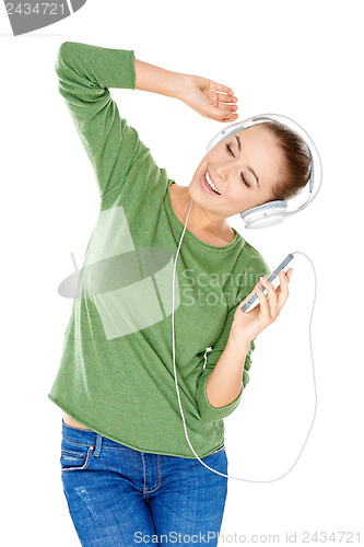 Image of Blissful woman dancing and listening to music