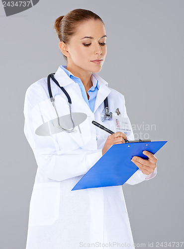 Image of Doctor writing on a patients file