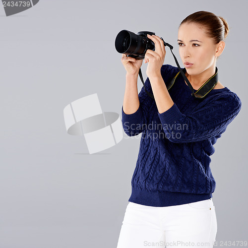 Image of Female photographer assessing her shot