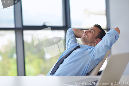 Image of happy young business man at office