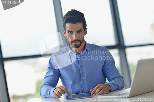 Image of happy young business man at office