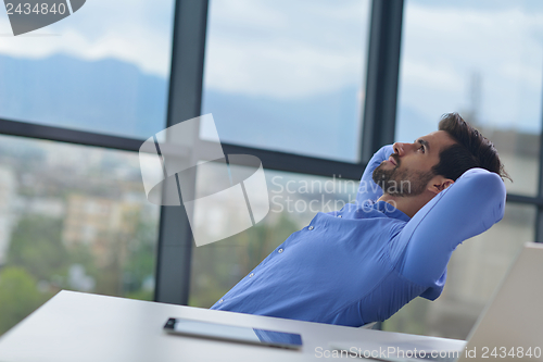 Image of happy young business man at office